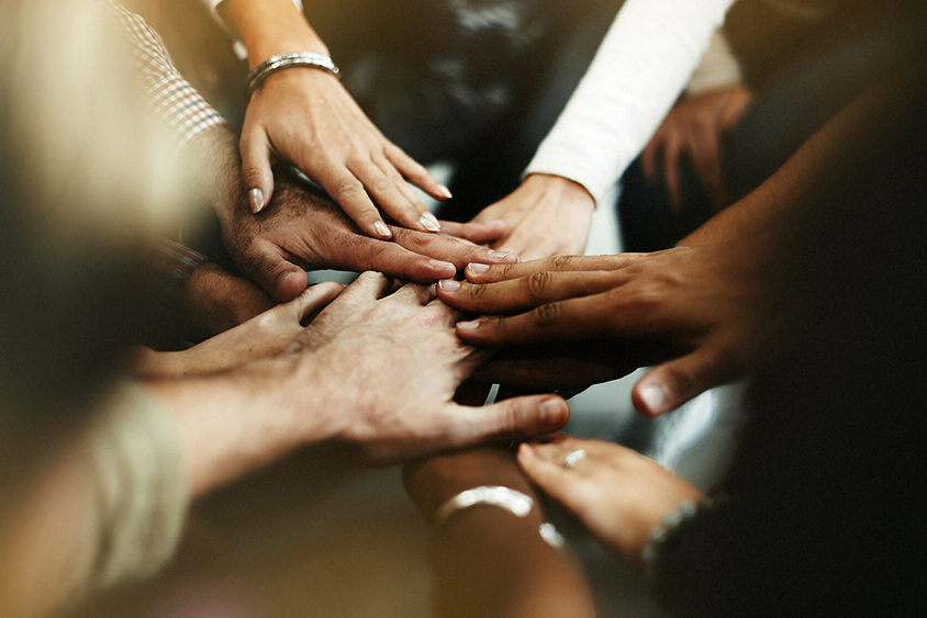 People making pile of hands